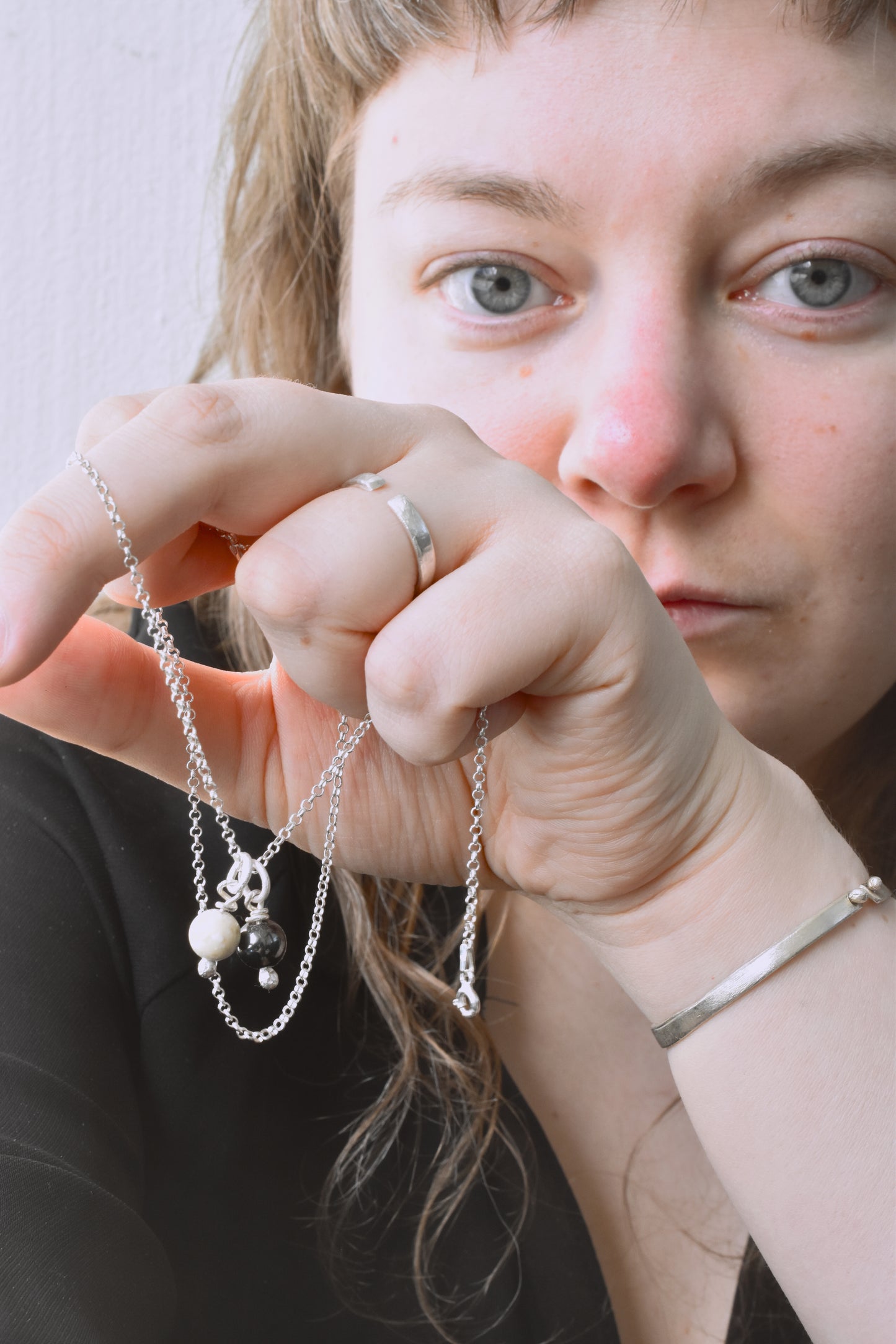 Silver white stone and hematite charms shown worn together on chain