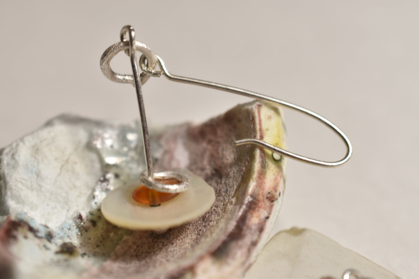 Flying saucer earrings with vintage shell and amber, close-up detail view