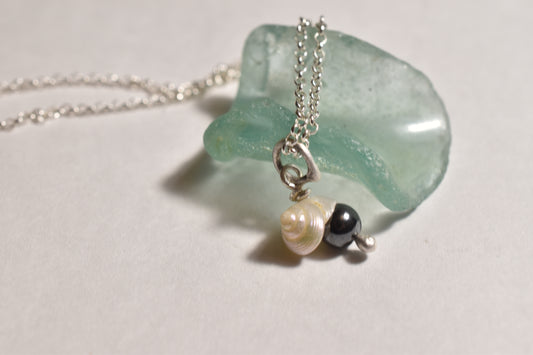 Silver seashell hematite pendant with vintage shell on silver chain, detail view