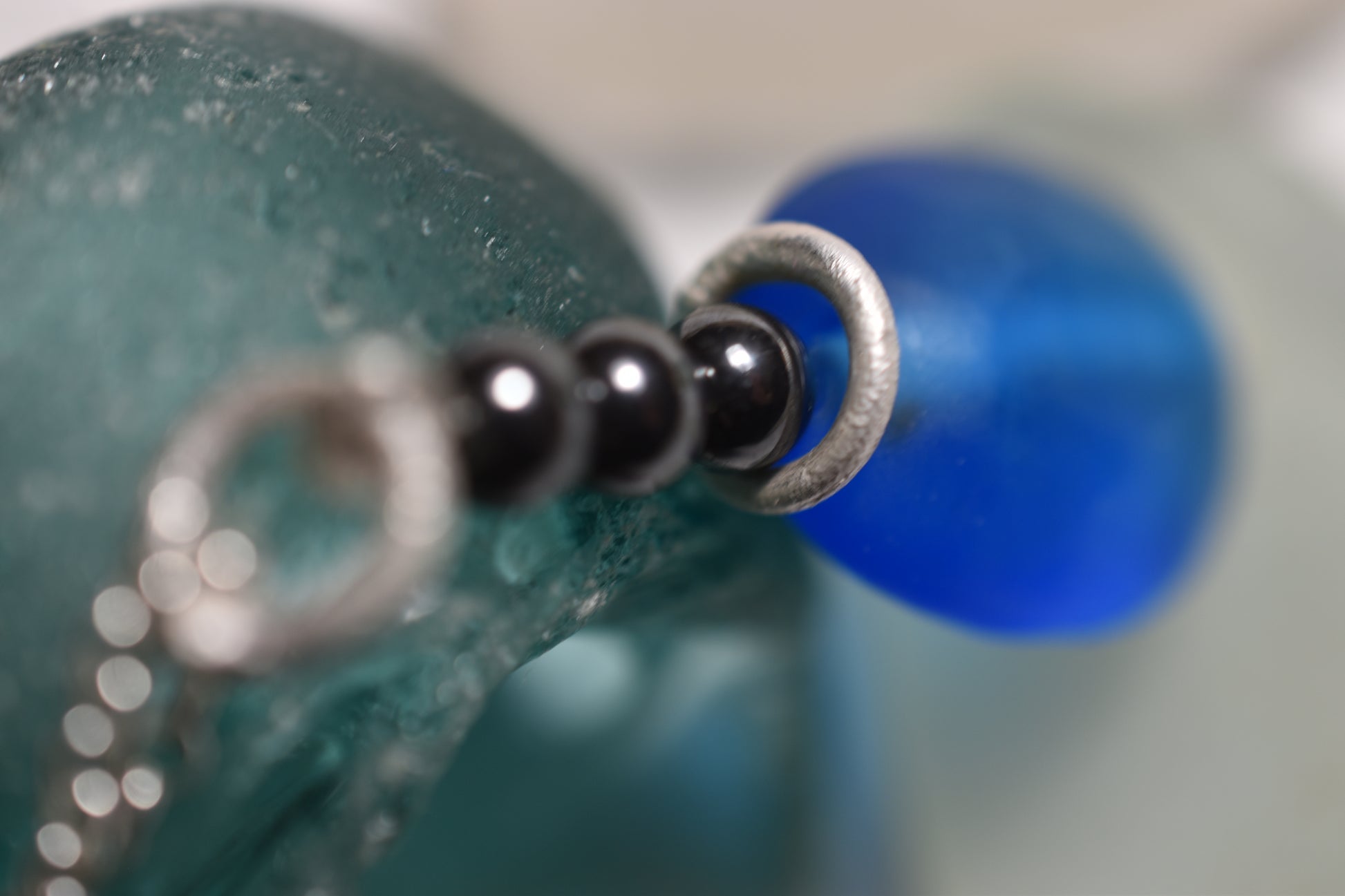 Blue glass and hematite handmade silver pendant, detail of deep blue bead