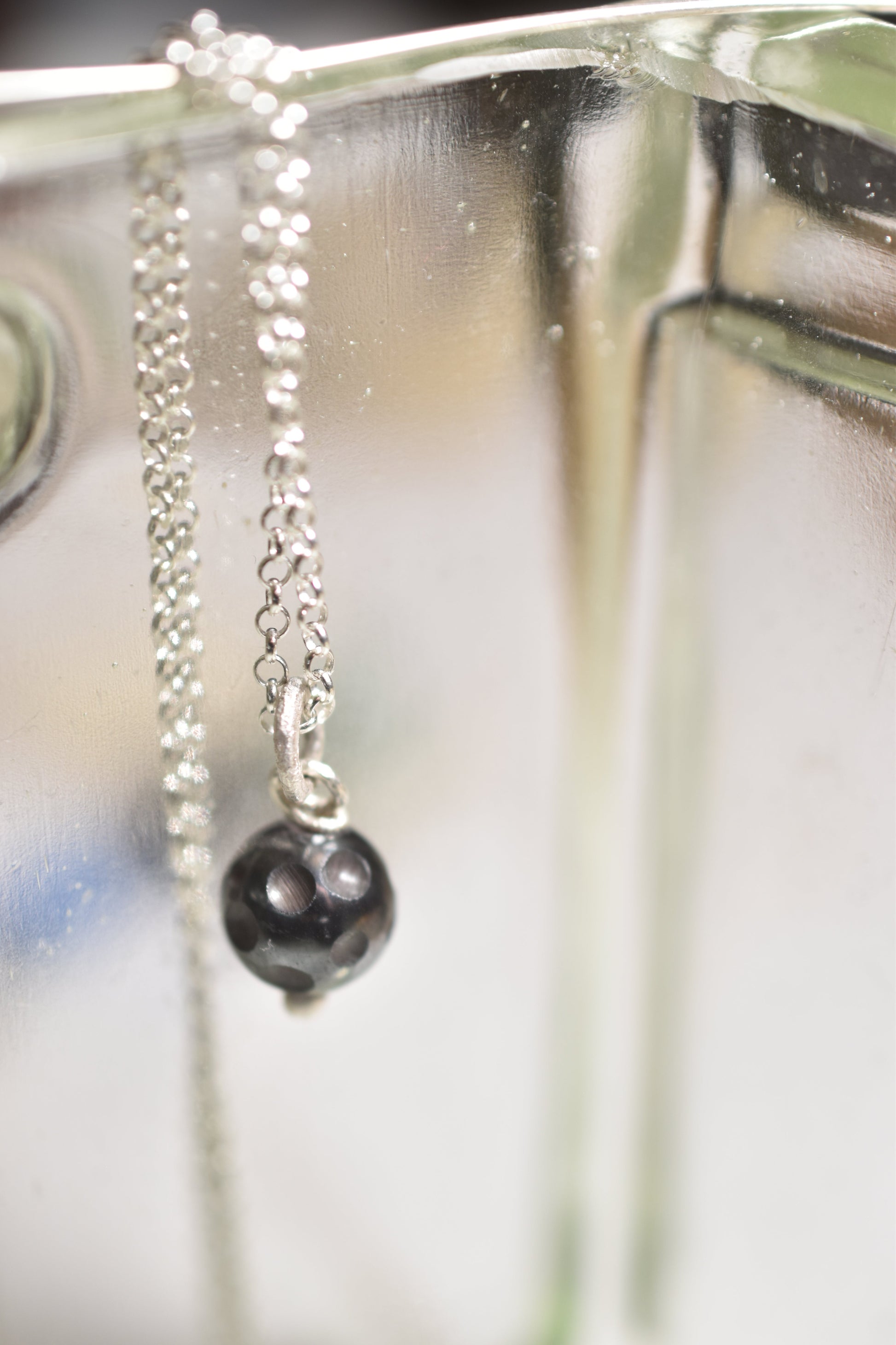 Silver hematite crater handmade pendant hanging from silver chain