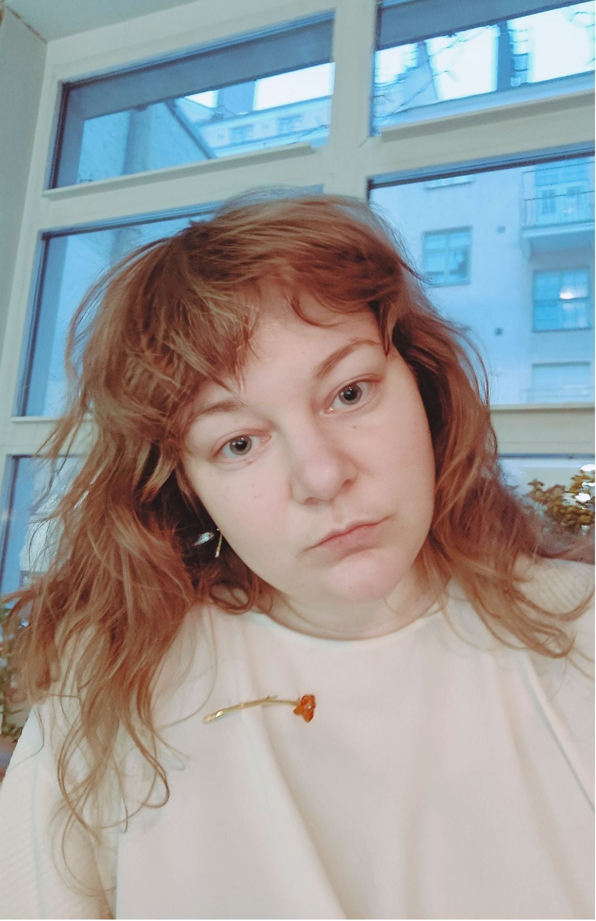 Fool's Gold amber brooch with golden brass shimmer, shown worn on shirt