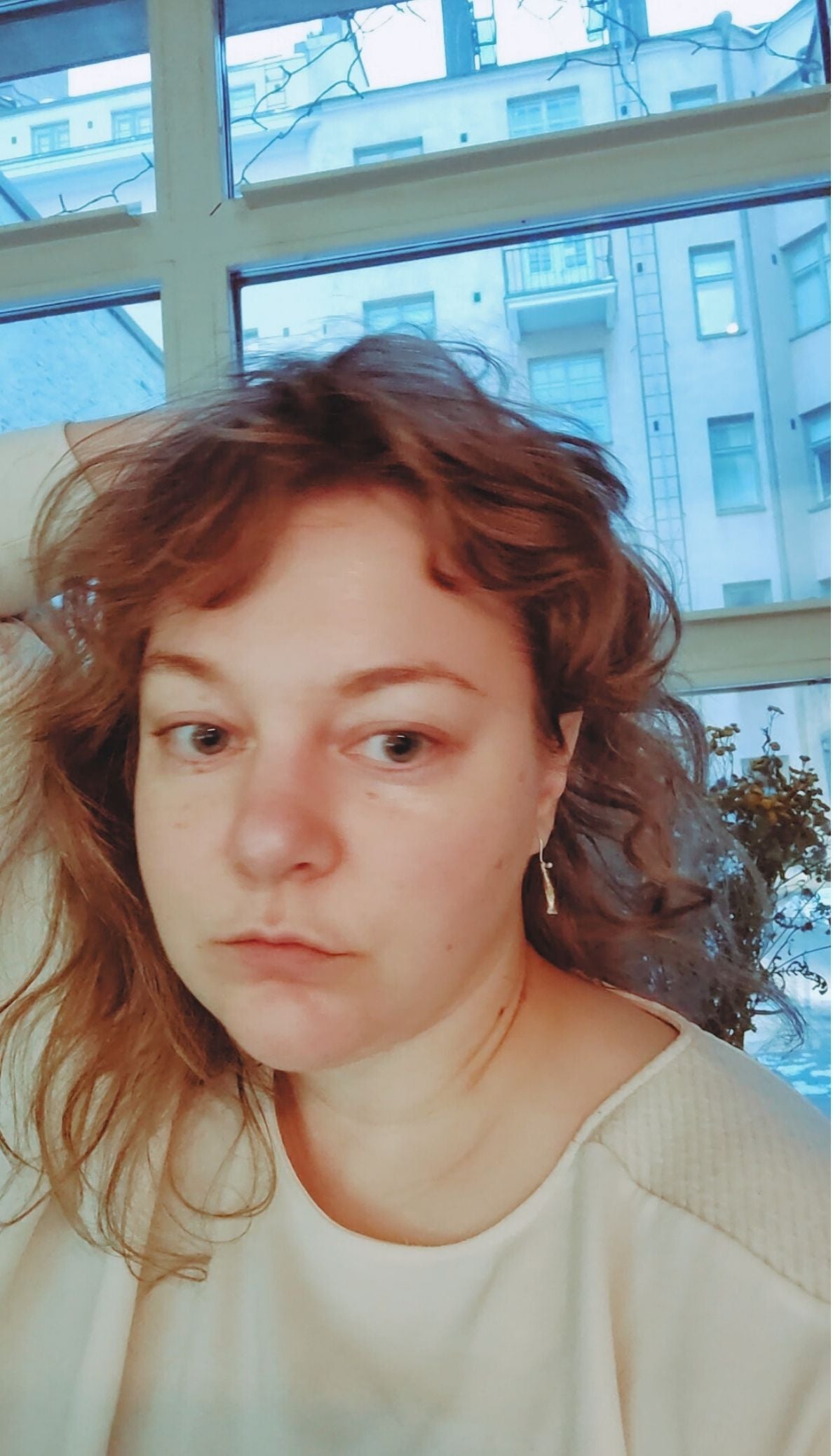 Short Fool's Gold earrings with golden brass shown worn on ear