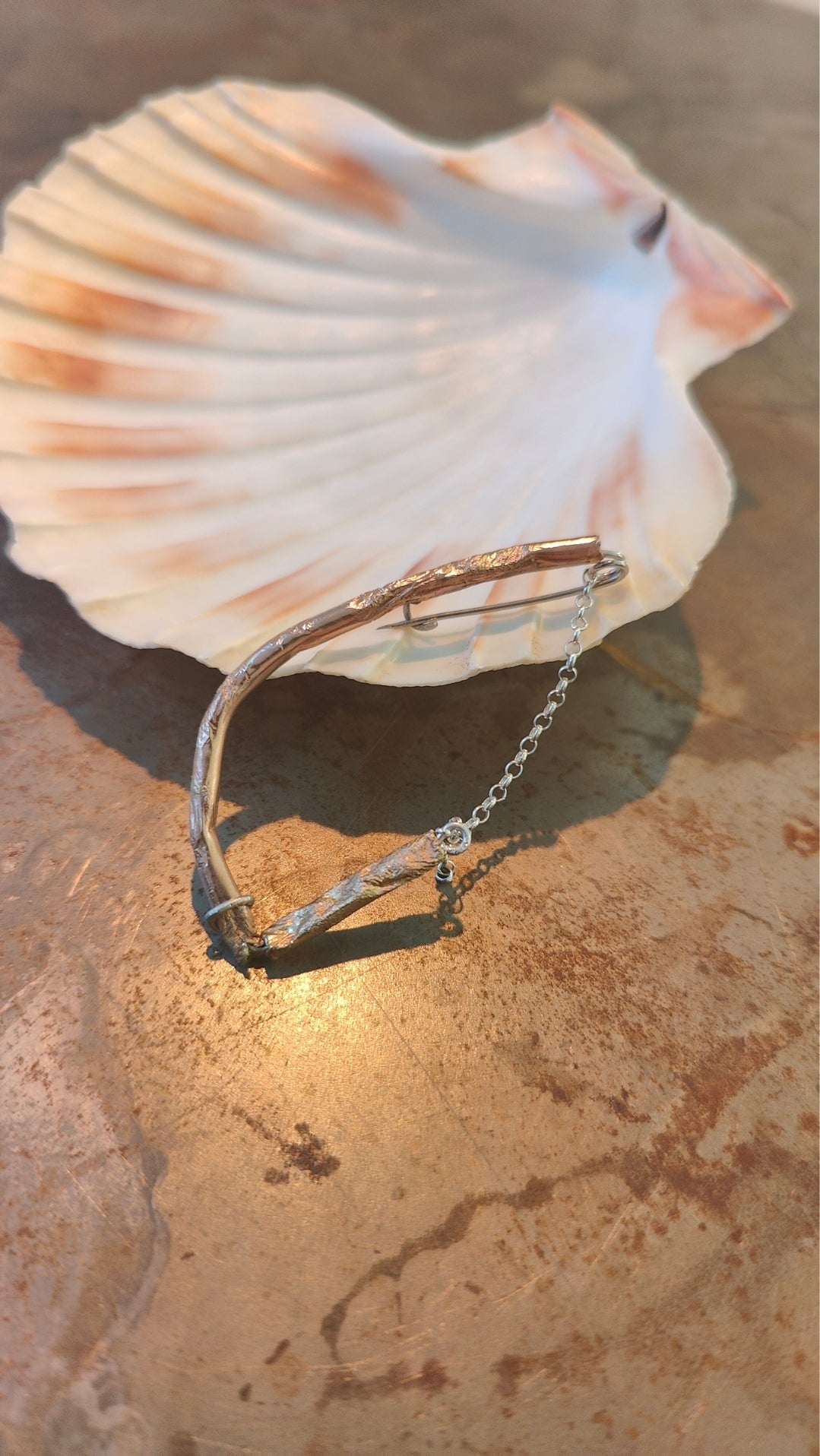 Fool's Gold brooch with brass and silver, close-up detail view