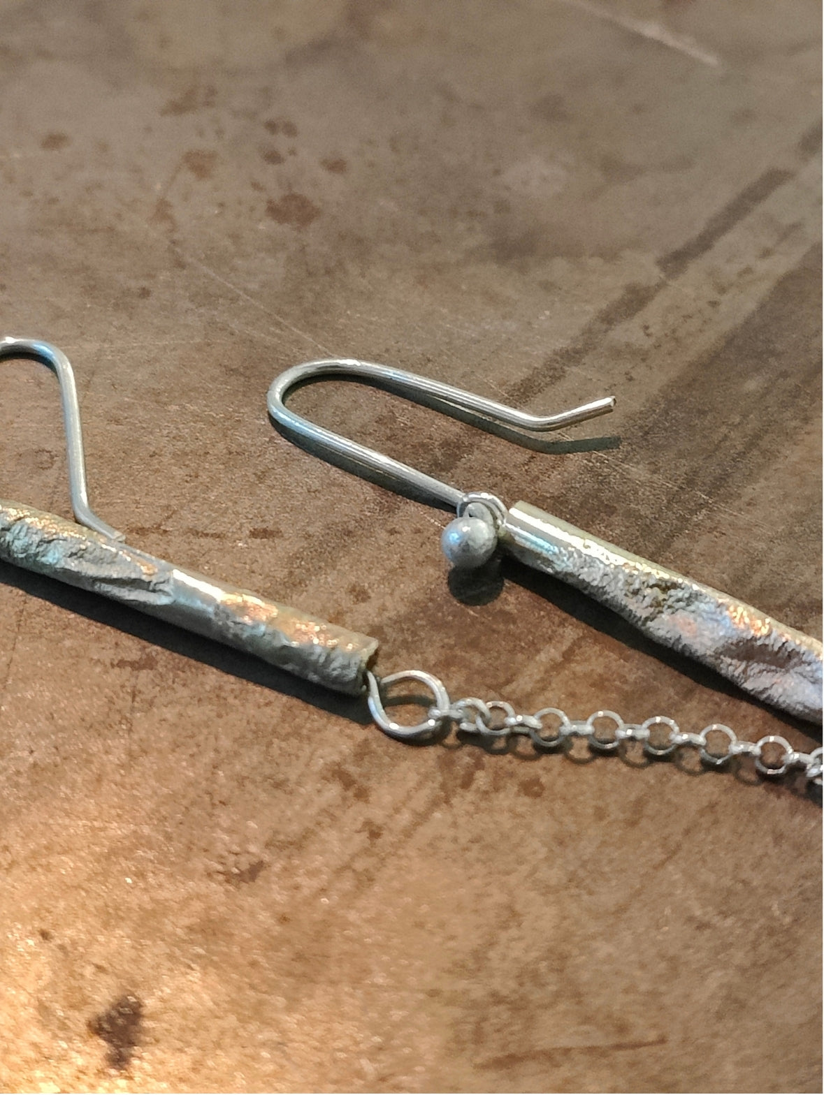 Long Fool's Gold earrings with golden brass shimmer, detail view