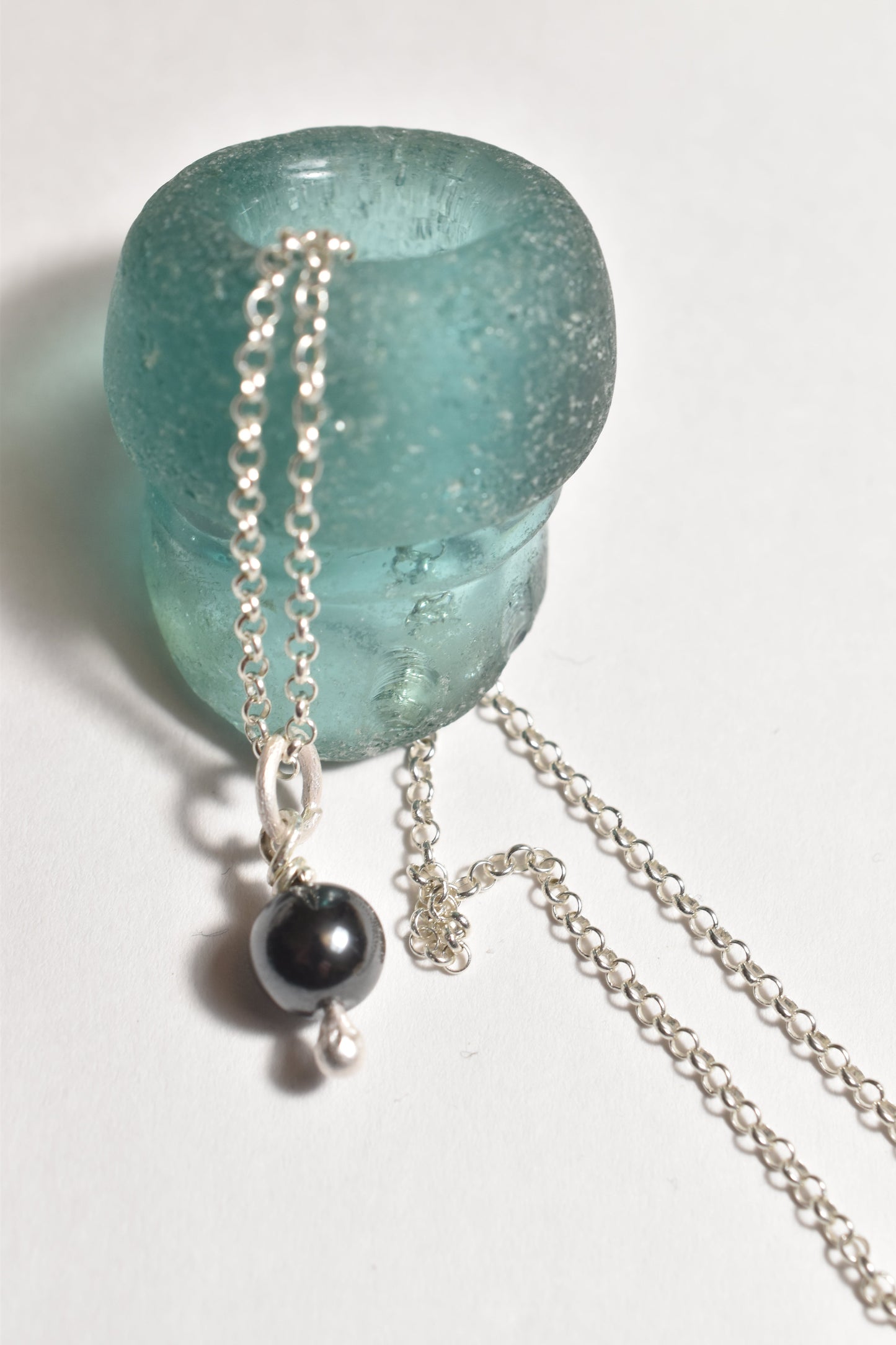 Silver hematite small charm on recycled sterling silver, close-up