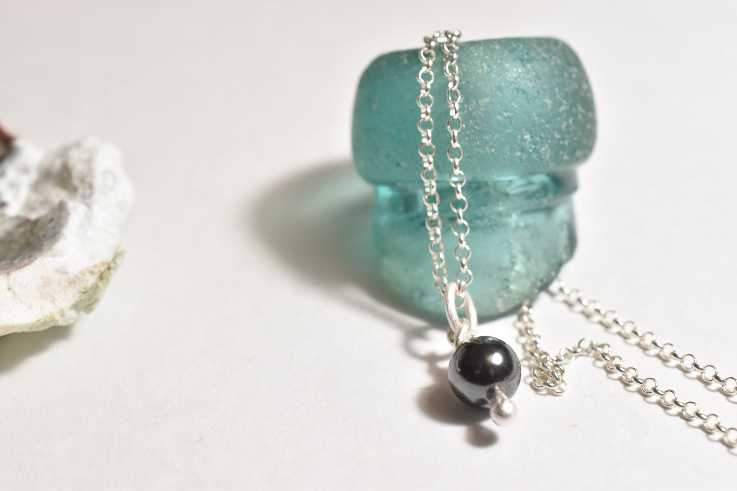 Silver hematite handmade charm with natural black stone, detail view