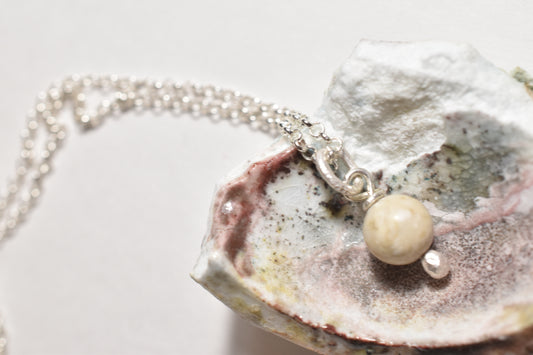 Silver white stone charm pendant on sterling silver chain, detail view